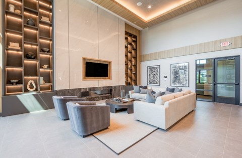 a living room with couches and chairs and a television